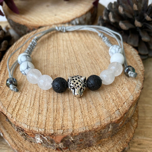 Selenite, howlite and lava stone bead with a jaguar charm.