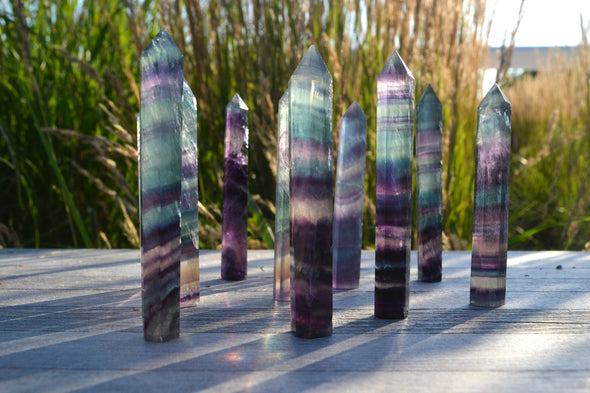 Beutiful rainbow fluorite towers 9x1 cms . purple and teal colours  with stripes
