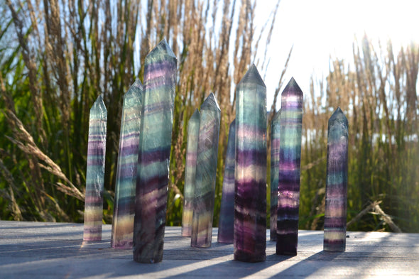 Beutiful rainbow fluorite towers 9x1 cms . purple and teal colours with stripes